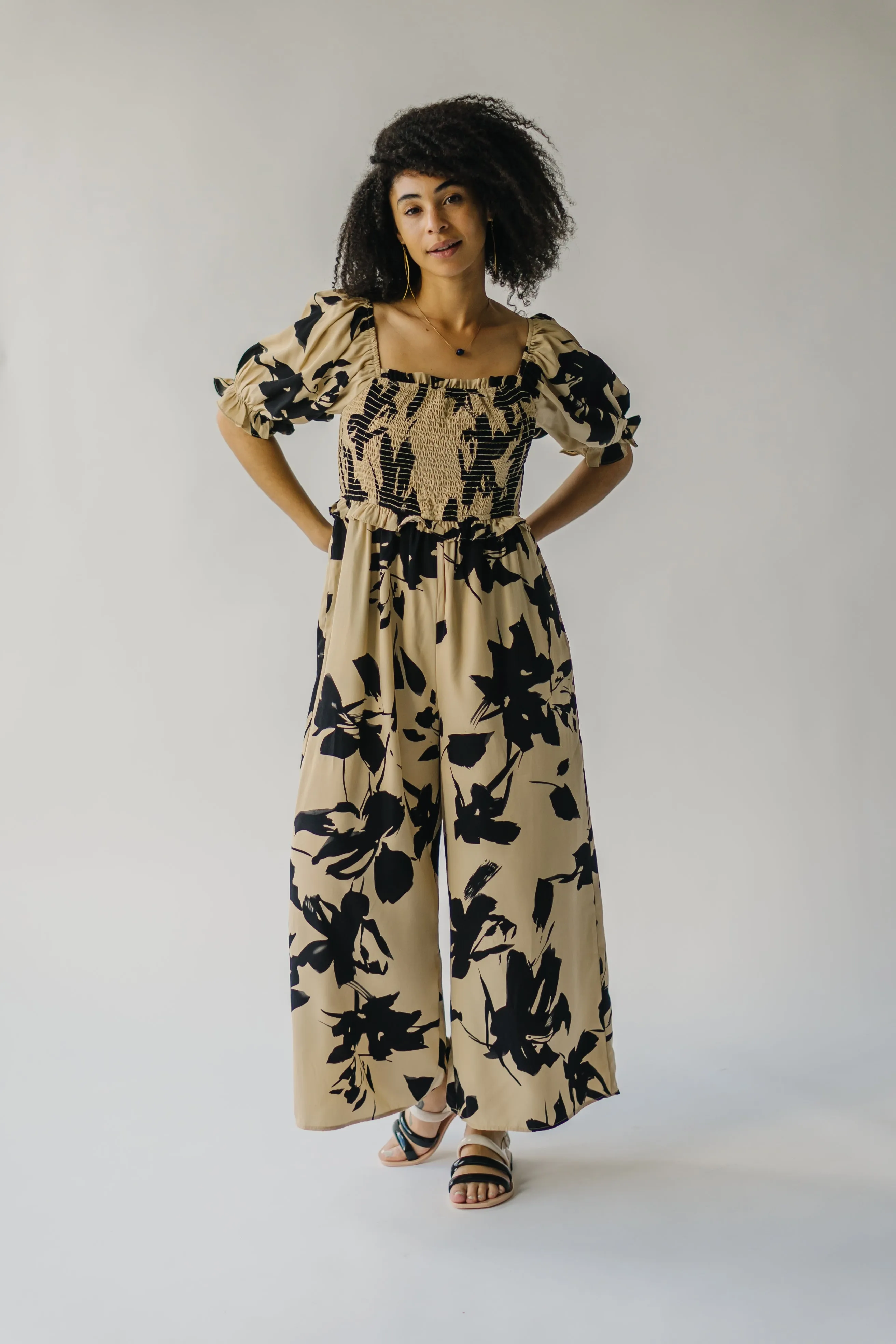 The Maggard Smocked Floral Jumpsuit in Taupe